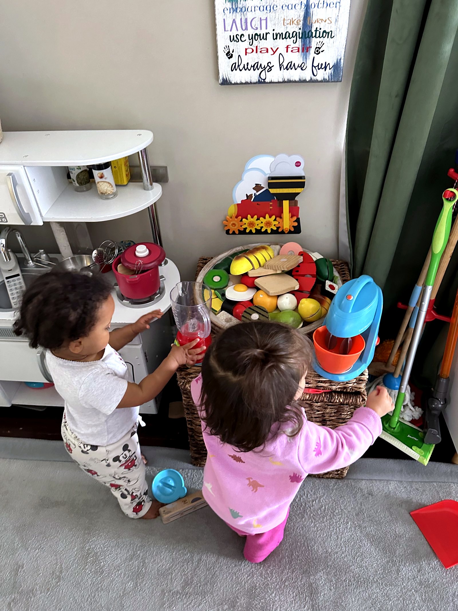 Children cooking together in the play kitchen