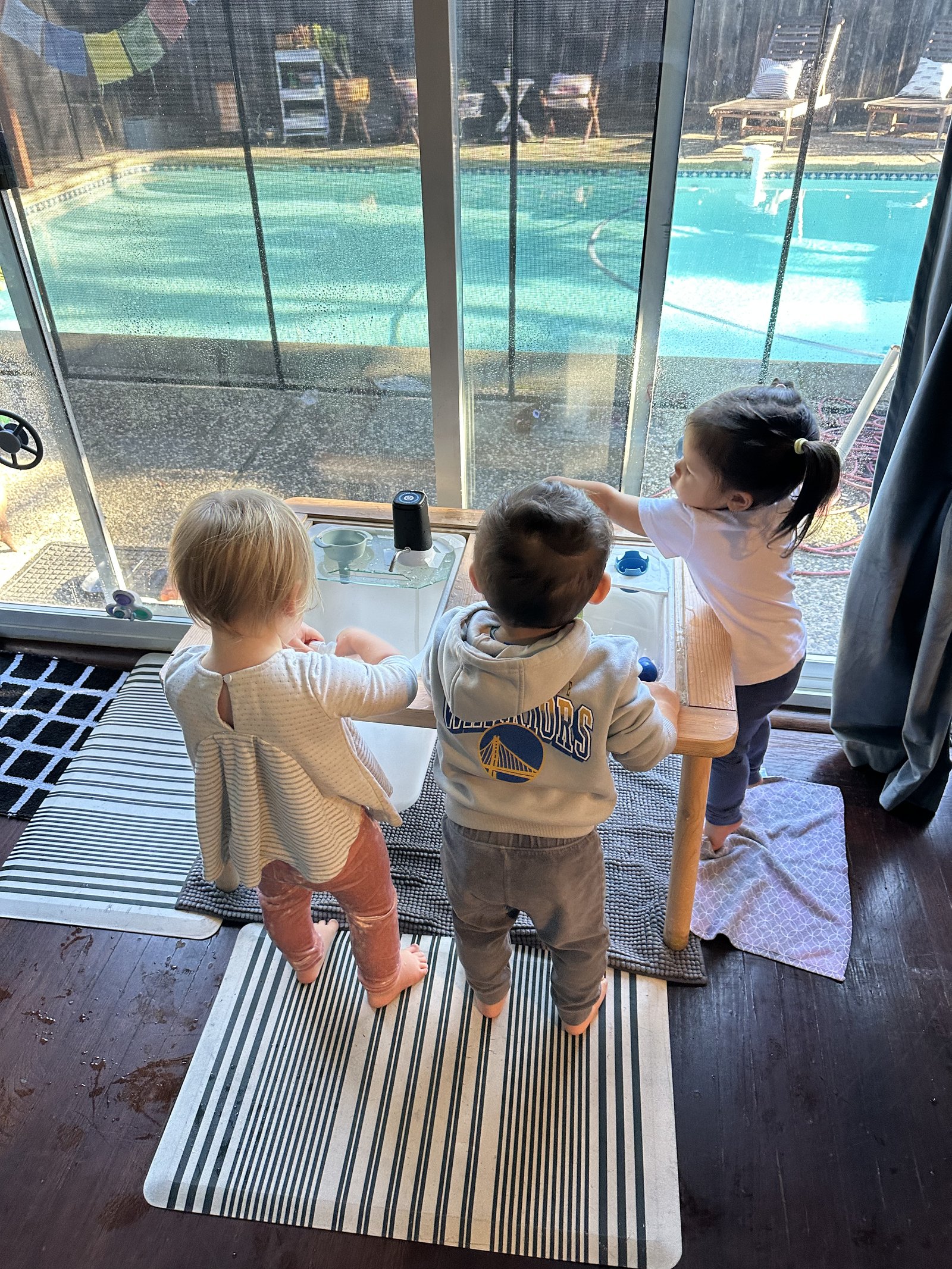 Children exploring together at the water table