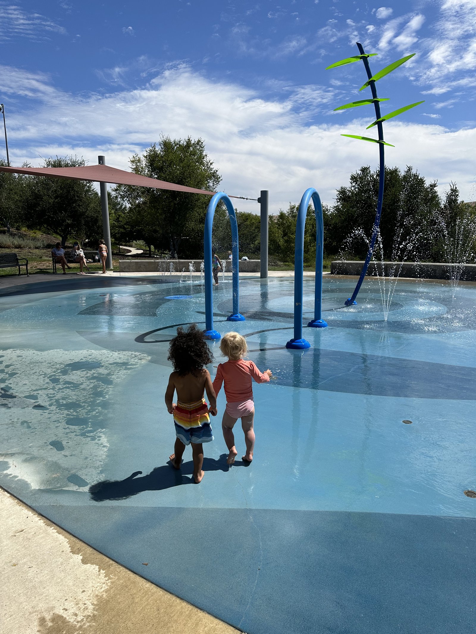 Children holding hands at the splash pad